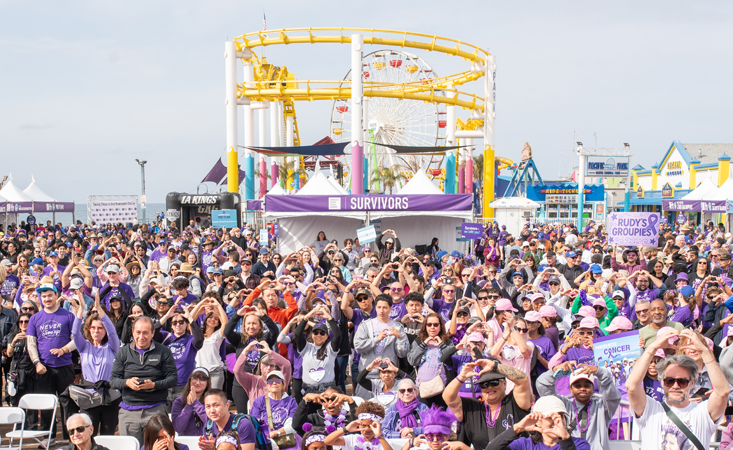 Feature image Crowd of more than 1,000 people making hand hearts at PurpleStride 2026.