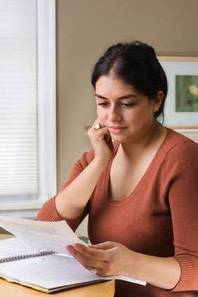 A woman looks at medical information to understand her diagnosis.