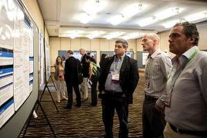 Eric Lutz, PhD (middle, foreground) describes his 2013 Career Development Award project to attendees while Yuliya Pylayeva-Gupta, PhD (background, left) explains her work funded by a 2013 Pathway to Leadership Grant. Photo ©2014 AACR/Todd Buchanan 