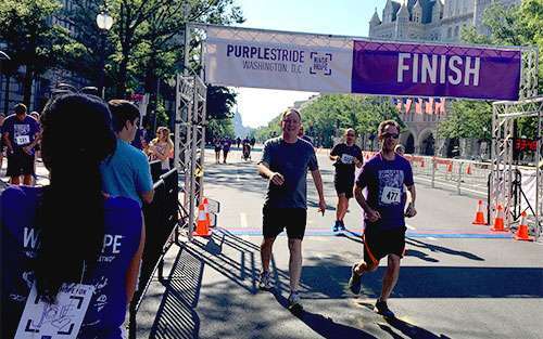 Walkers and runners cross finish line at PurpleStride Washington D.C., the walk to end pancreatic cancer