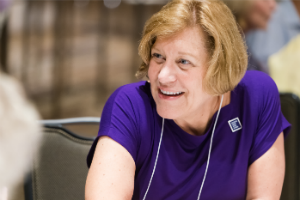 PanCAN’s Chief Science Officer Lynn Matrisian, PhD, speaks with attendees at an event table.