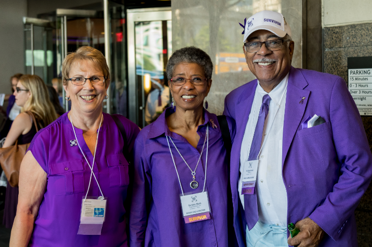 Feature image Three long-term survivors and PanCAN volunteers dressed in purple standing united together.