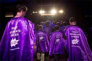 Attendees dress in capes as part of the meeting’s superhero theme.
