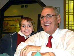 A young boy smiles with his grandfather who passed away from pancreatic cancer
