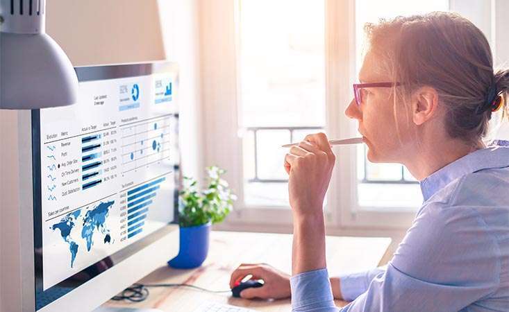 Feature image Woman is reviewing global cancer statistics and charts on her computer.