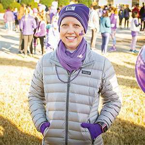 Organizer and pancreatic cancer survivor smiles at her DIY event to raise money and awareness