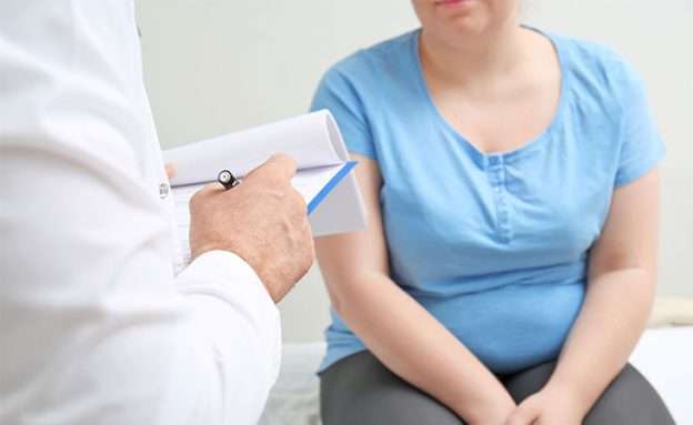 Feature image A young adult and her doctor discuss obesity as a risk factor for pancreatic cancer