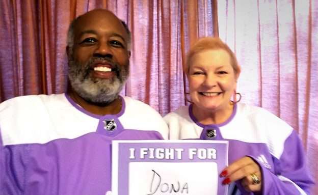 Feature image Husband and wife wearing Hockey Fights Cancer jerseys as she battles pancreatic cancer
