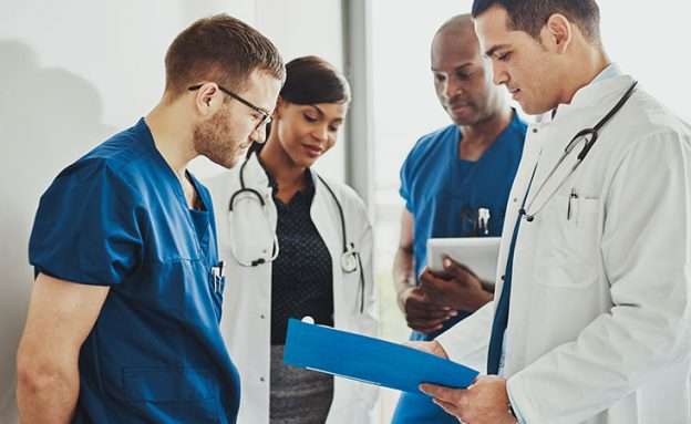 Feature image Doctors read updated guidelines for treating pancreatic cancer patients