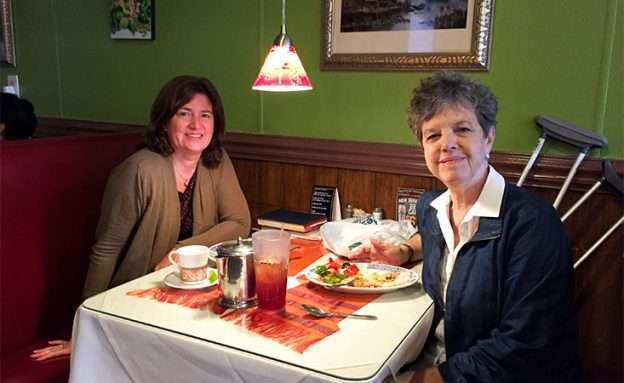 Feature image Pancreatic neuroendocrine tumor survivor enjoys dinner at a restaurant with a friend