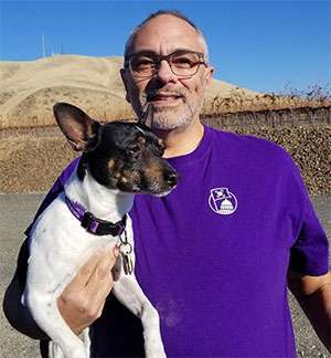 Pancreatic cancer survivor and his dog sport PanCAN gear to spread awareness for the disease.
