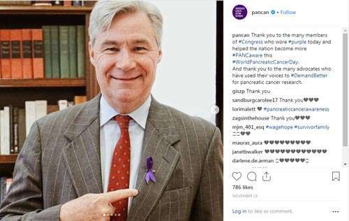 Congressman points to purple ribbon on his jacket in honor of World Pancreatic Cancer Day