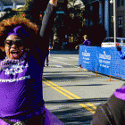 Participant celebrates crossing finish line at 5k walk in Charlotte to end pancreatic cancer