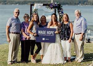 Pancreatic cancer survivor and volunteers join bride on her wedding day with Wage Hope sign