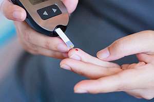 Pancreatic cancer patient with diabetes checks blood sugar levels