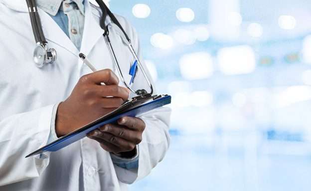 Feature image African-American oncologist reviews new ASCO pancreatic cancer guidelines on tablet