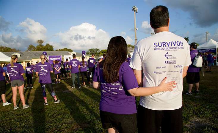 Pancreatic cancer survivor with participant at PanCAN’s PurpleStride walk/run event