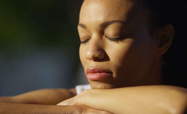 Feature image Pancreatic cancer caregiver takes a moment for self-care to meditate outside