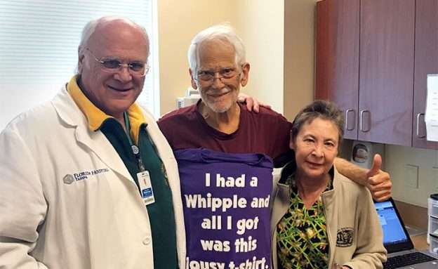 Pancreatic cancer patient and his wife stand with surgeon who performed his Whipple procedure