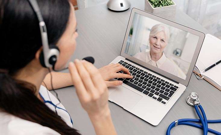 Pancreatic cancer patient has a telemedicine video phone call with her oncologist
