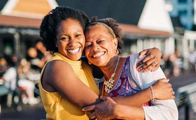Feature image Mother, a pancreatic cancer survivor, smiling and hugging her daughter, a PanCAN volunteer