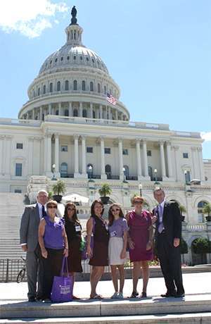 Pancreatic cancer survivor surrounded by family in front of the U.S. Capitol building