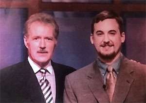 Smiling man in his 20's with Alex Trebek, TV host of Jeopardy!, circa 2000