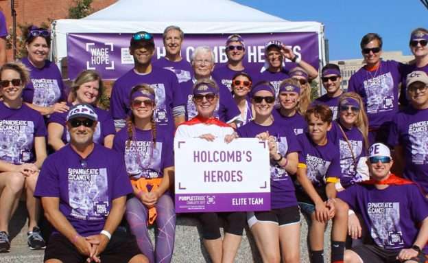 Feature image Stage 4 pancreatic cancer survivor with friends and family at PanCAN PurpleStride event