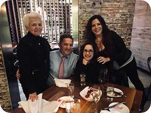 Pancreatic cancer survivor Susan Schultz with children, including caregiver Lauren, seated