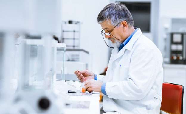 Feature image Pancreatic cancer researcher examining blood sample