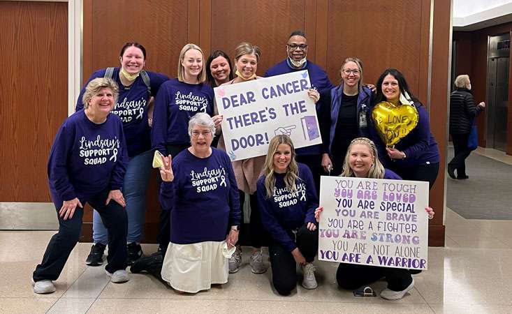 Feature image A group of people holding encouraging signs about beating pancreatic cancer.