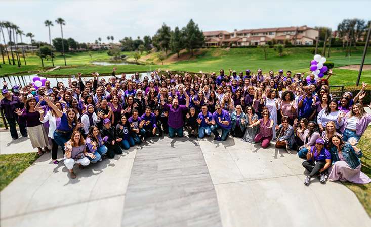 Feature image Around 150 staff members of the Pancreatic Cancer Action Network posing for a group shot outdoors in the sun