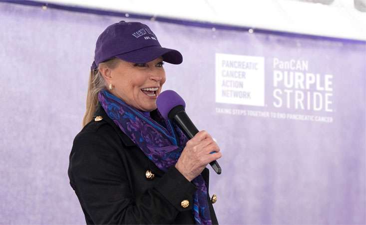 Feature image Lisa Niemi Swayze speaking on stage at PanCAN PurpleStride