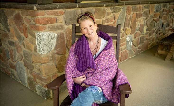 Feature image Melissa Gilbert wrapped in the Modern Prairie x PanCAN Scalloped Throw