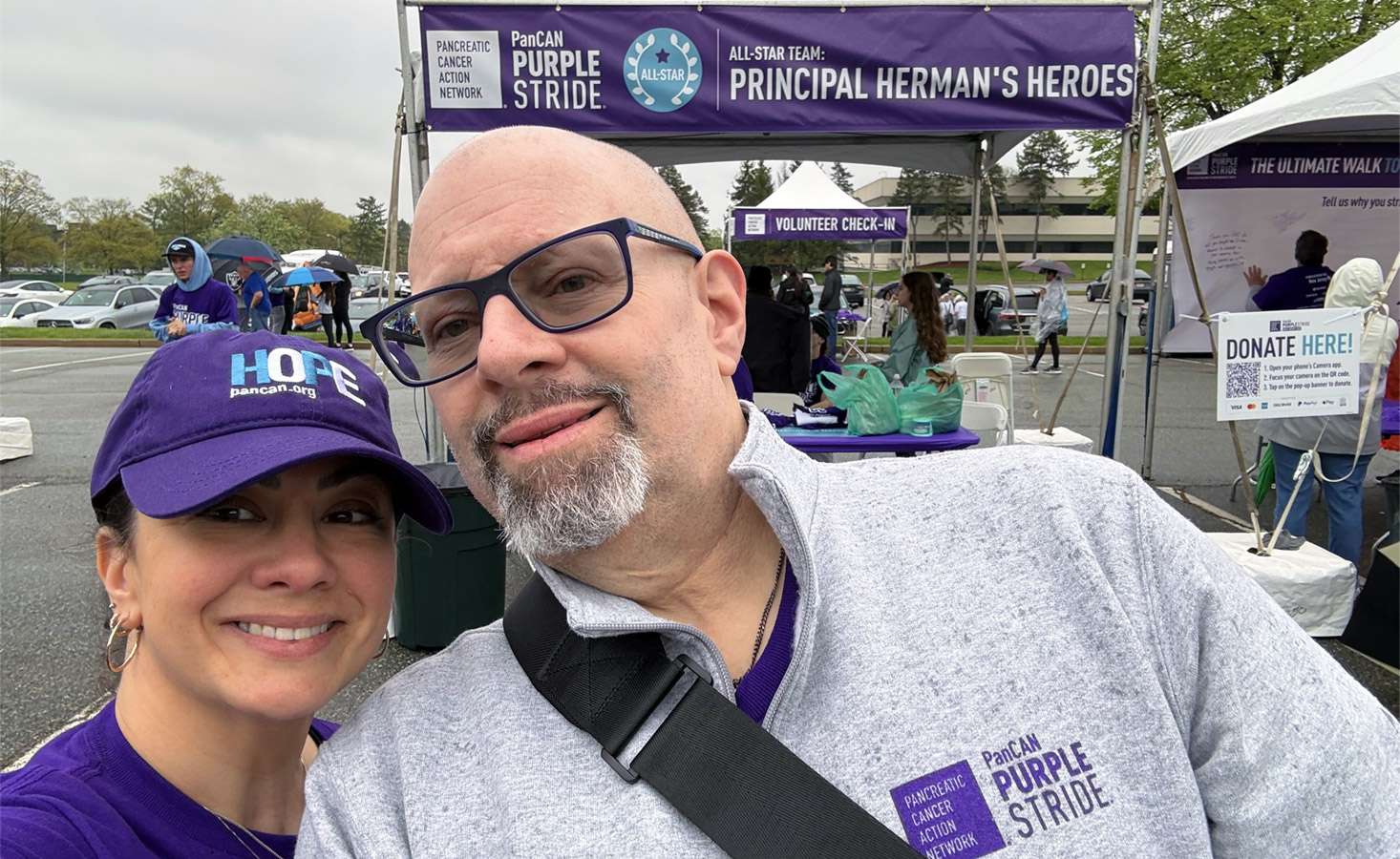 Feature image A selfie of a man and woman standing in front of an event tent at PanCAN PurpleStride 2025.